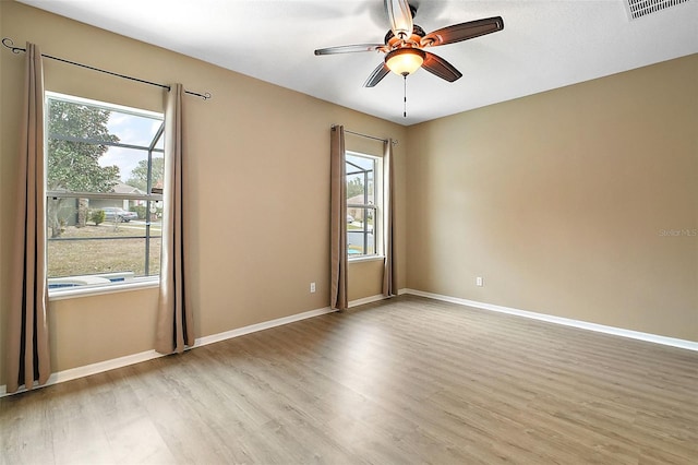 empty room with light wood-type flooring and ceiling fan