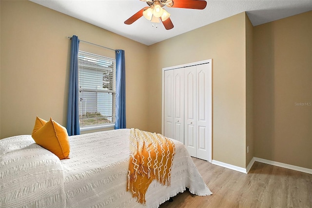 bedroom featuring a closet, ceiling fan, and light hardwood / wood-style flooring