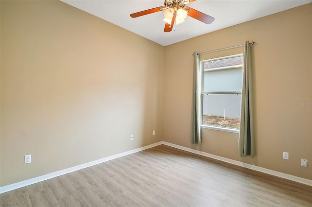 spare room with ceiling fan and light wood-type flooring