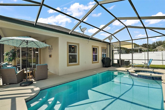 view of swimming pool featuring a patio area, an in ground hot tub, and glass enclosure