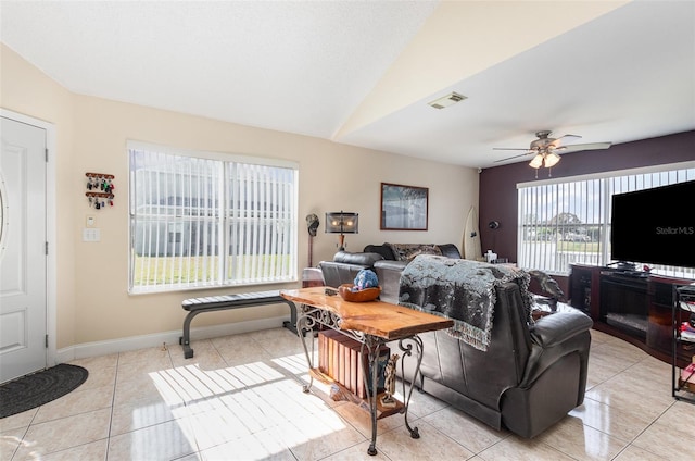 living room featuring lofted ceiling, plenty of natural light, and light tile patterned flooring