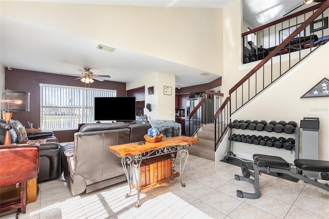 tiled living room with ceiling fan