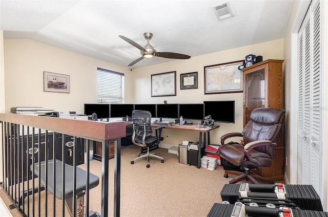 carpeted office space with ceiling fan, a textured ceiling, and lofted ceiling