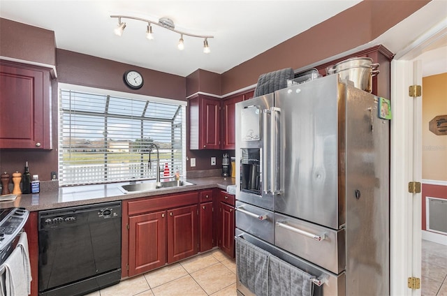 kitchen with sink, light tile patterned floors, and appliances with stainless steel finishes