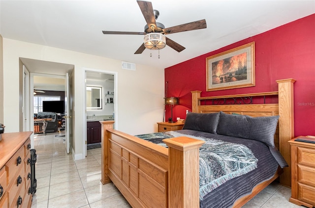 bedroom featuring ceiling fan, light tile patterned floors, and ensuite bathroom