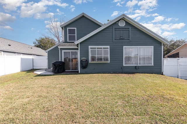 back of house with a lawn