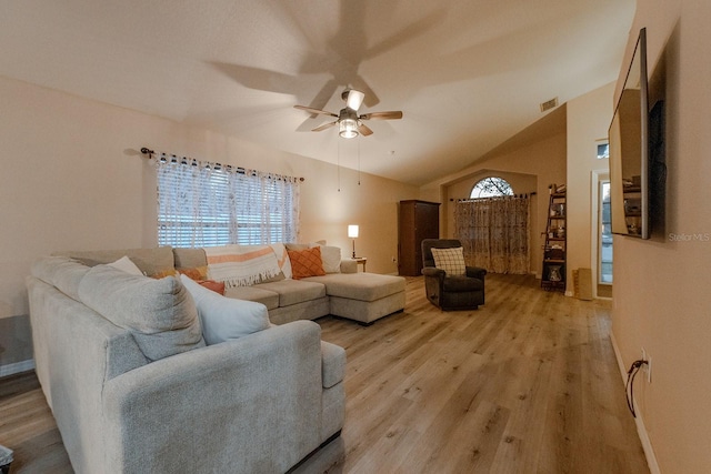 living room featuring lofted ceiling, ceiling fan, and light hardwood / wood-style flooring