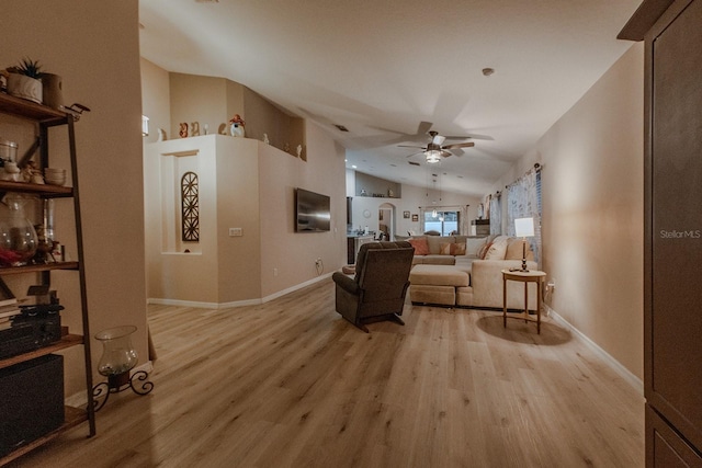 living room with lofted ceiling, ceiling fan, and light hardwood / wood-style floors