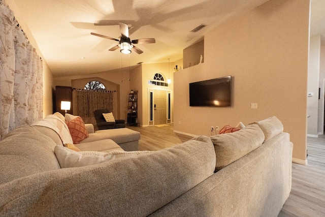 living room with vaulted ceiling, ceiling fan, and light hardwood / wood-style floors