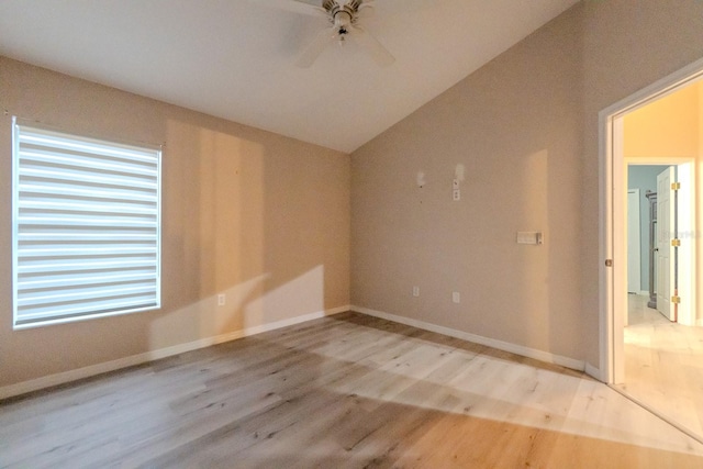 spare room featuring vaulted ceiling, ceiling fan, and light hardwood / wood-style floors