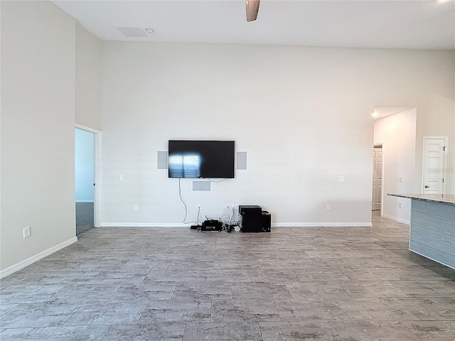 unfurnished living room with ceiling fan