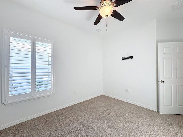 carpeted empty room featuring ceiling fan