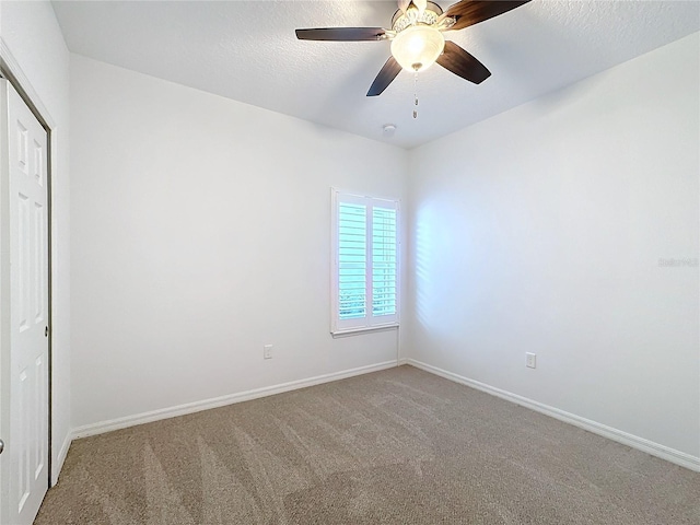 unfurnished bedroom featuring ceiling fan, carpet, a closet, and a textured ceiling