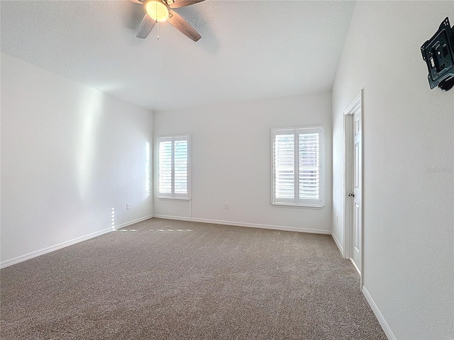 unfurnished room with a textured ceiling, ceiling fan, and carpet