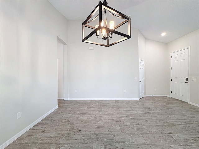 unfurnished dining area featuring an inviting chandelier