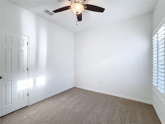 carpeted spare room featuring ceiling fan