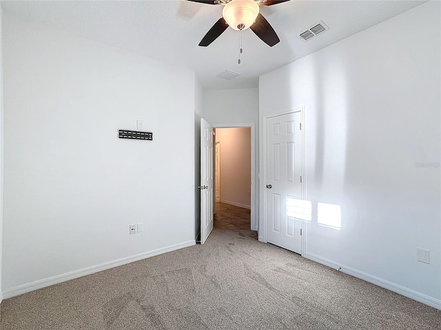 empty room with carpet floors and ceiling fan