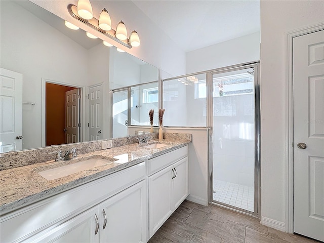 bathroom with walk in shower and vanity