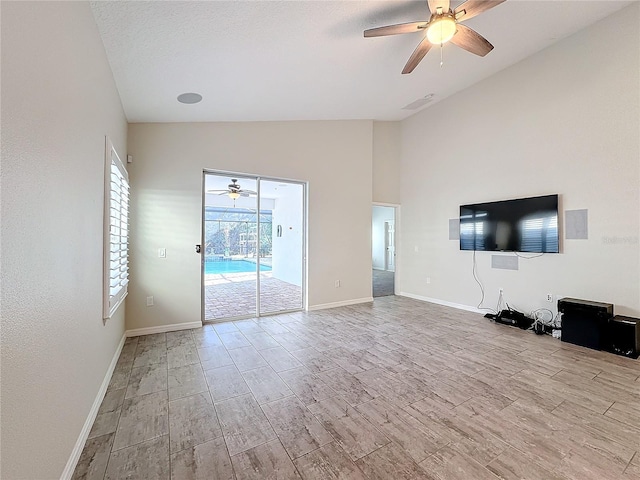 unfurnished living room featuring ceiling fan and lofted ceiling