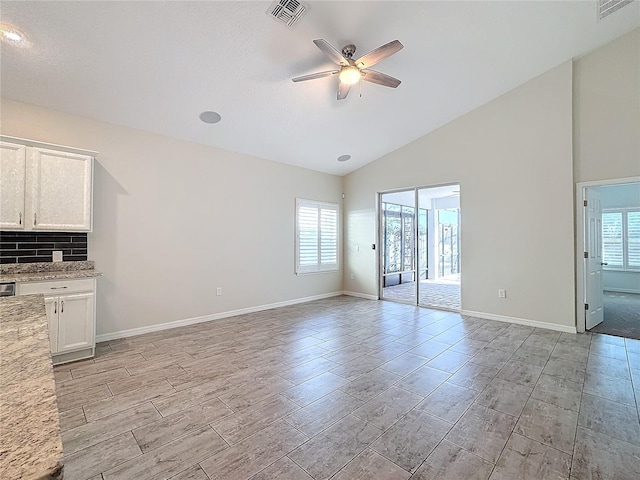 unfurnished living room featuring lofted ceiling and ceiling fan