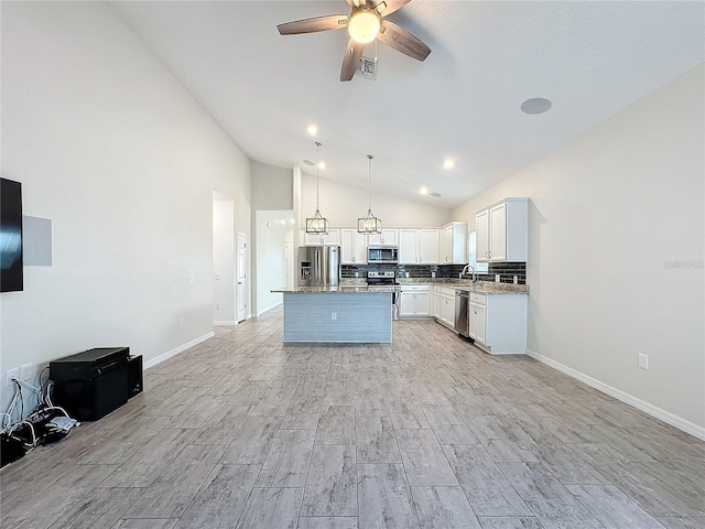 kitchen featuring white cabinetry, appliances with stainless steel finishes, backsplash, pendant lighting, and a center island