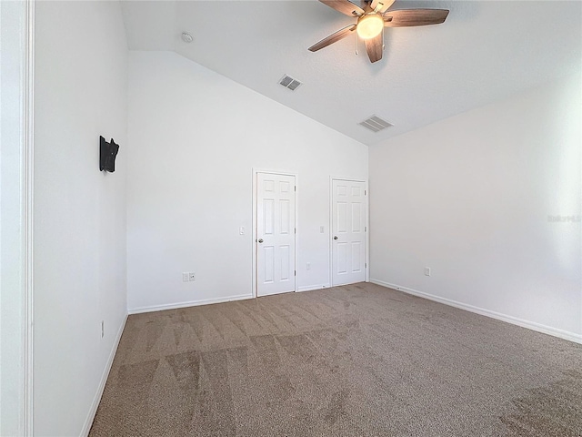 carpeted spare room featuring ceiling fan and high vaulted ceiling