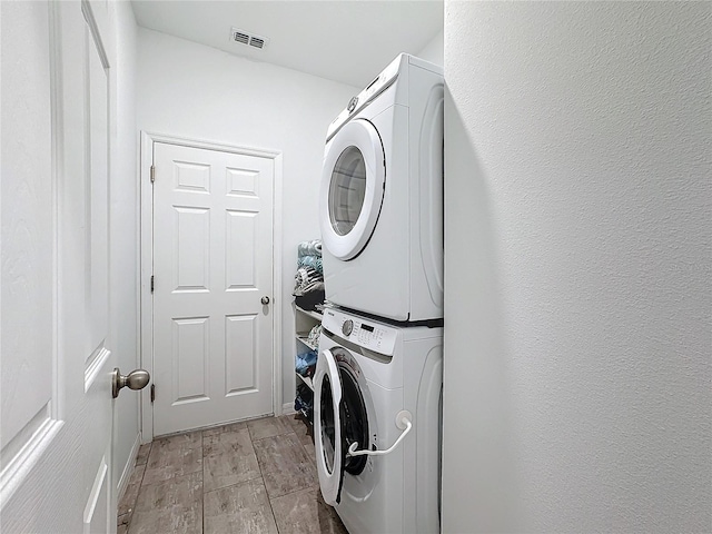 laundry room with stacked washer and clothes dryer