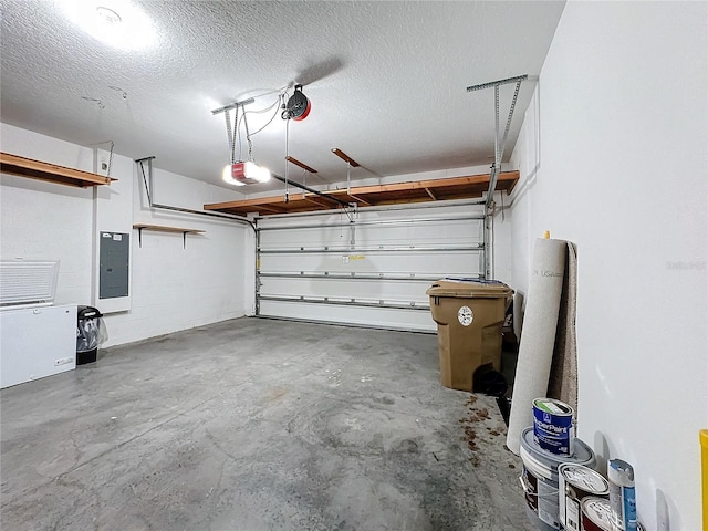 garage with a garage door opener and electric panel