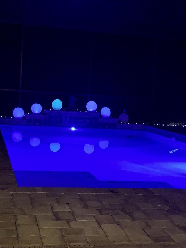 view of pool at night