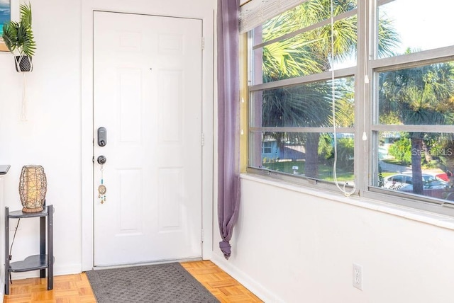 doorway to outside with light parquet floors