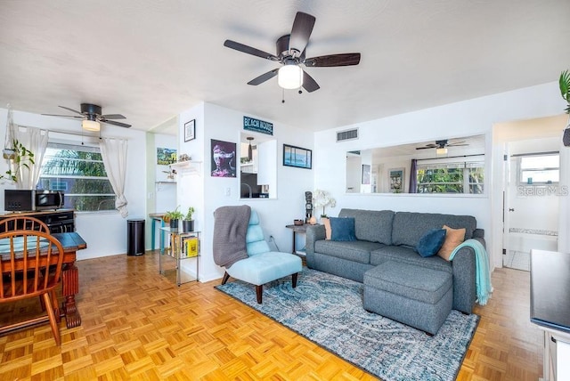 living room featuring a healthy amount of sunlight and light parquet flooring