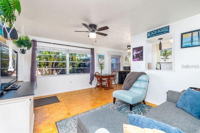 living room featuring parquet flooring and ceiling fan