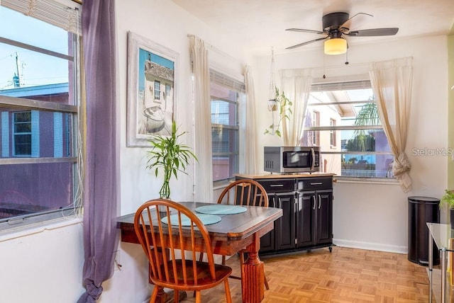 dining space featuring ceiling fan and light parquet floors