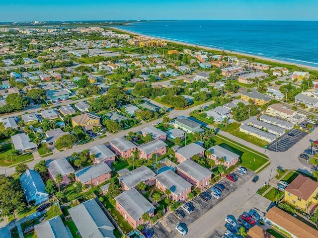 drone / aerial view with a water view and a view of the beach