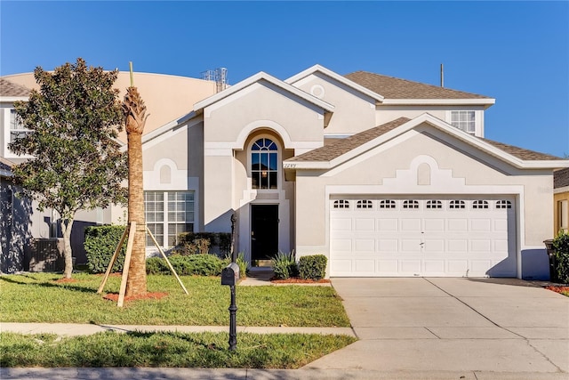 view of front of house with a front lawn and a garage