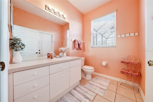 bathroom featuring toilet, vanity, and tile patterned floors