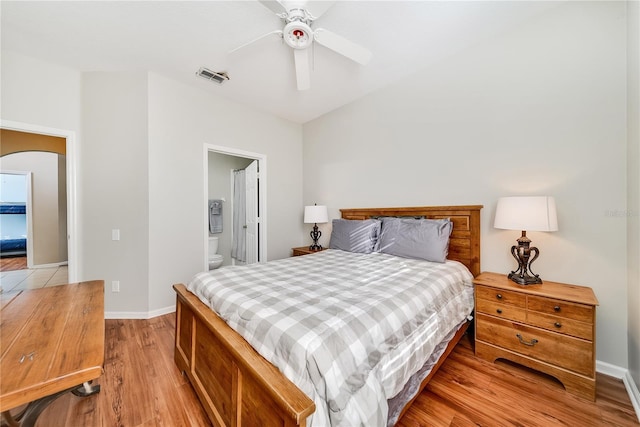 bedroom featuring ceiling fan, light wood-type flooring, and ensuite bathroom