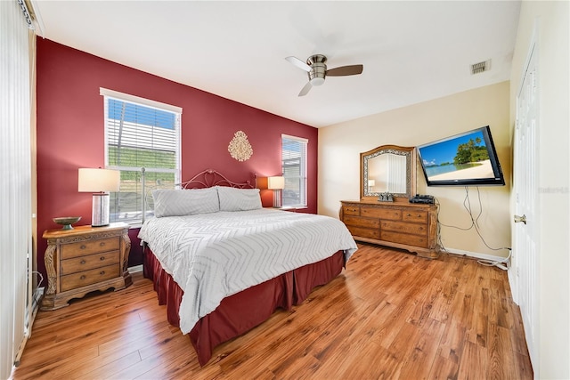 bedroom with light hardwood / wood-style floors and ceiling fan