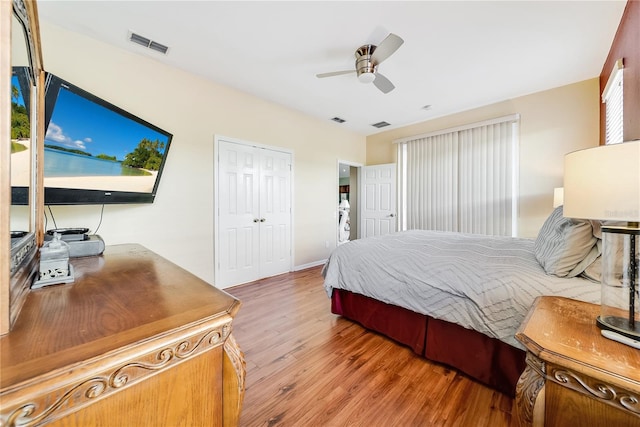 bedroom with a closet, ceiling fan, and hardwood / wood-style flooring