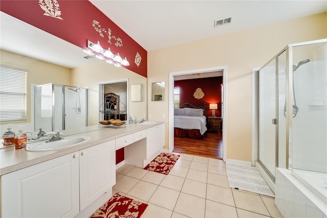 bathroom with plenty of natural light, tile patterned flooring, vanity, and an enclosed shower