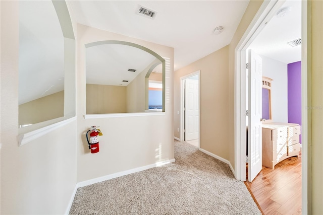 hall with wood-type flooring