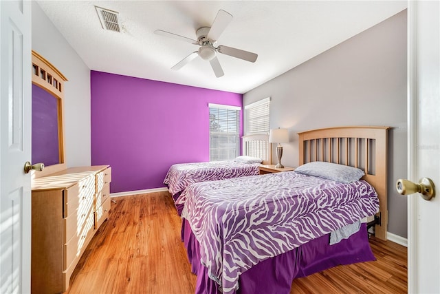 bedroom with ceiling fan and light hardwood / wood-style flooring