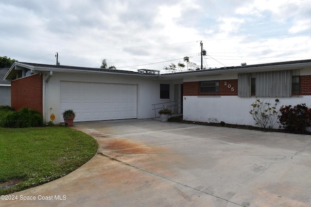 ranch-style house with a garage and a front lawn