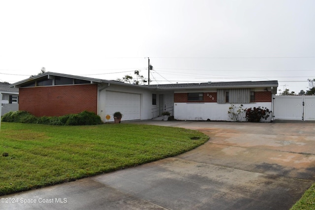 ranch-style home with a garage and a front lawn