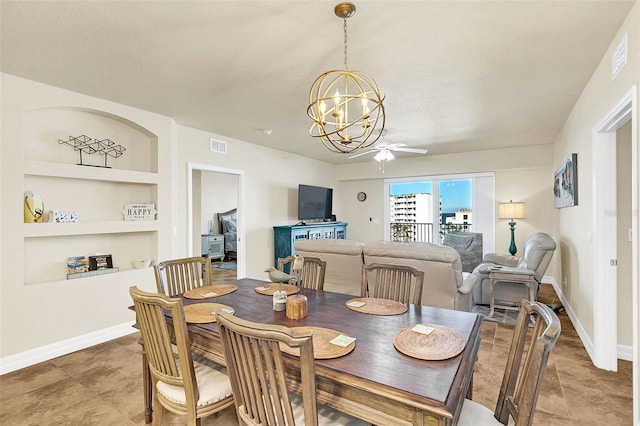 dining space with ceiling fan with notable chandelier and built in features