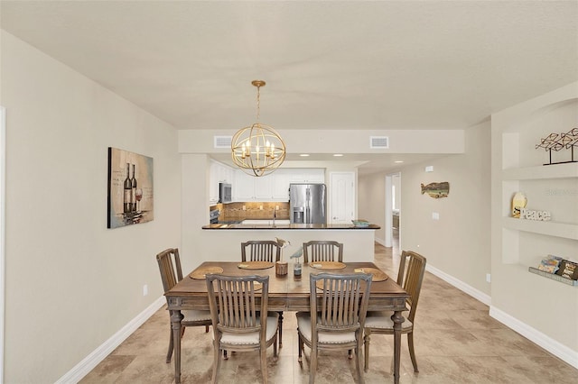 dining room with an inviting chandelier and built in shelves