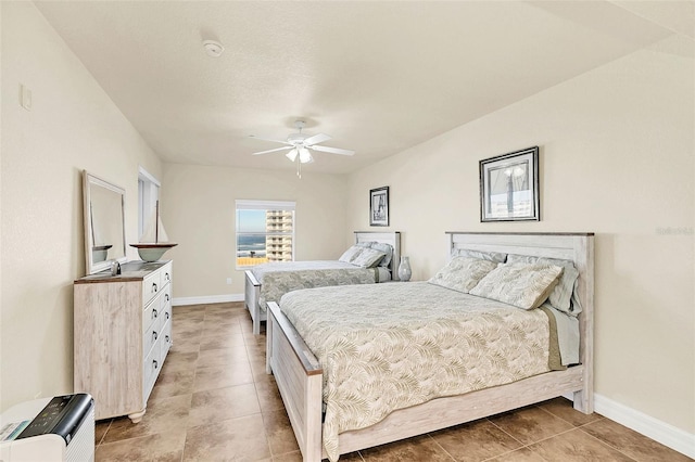 bedroom featuring ceiling fan and light tile patterned floors