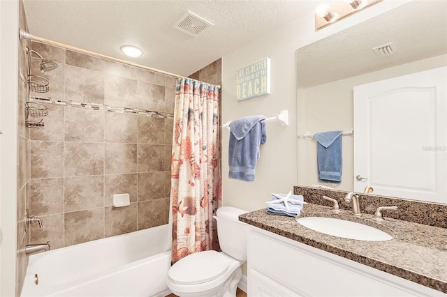 full bathroom featuring a textured ceiling, toilet, vanity, and shower / tub combo with curtain