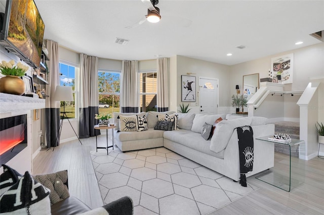 living room featuring a wealth of natural light and light wood-type flooring