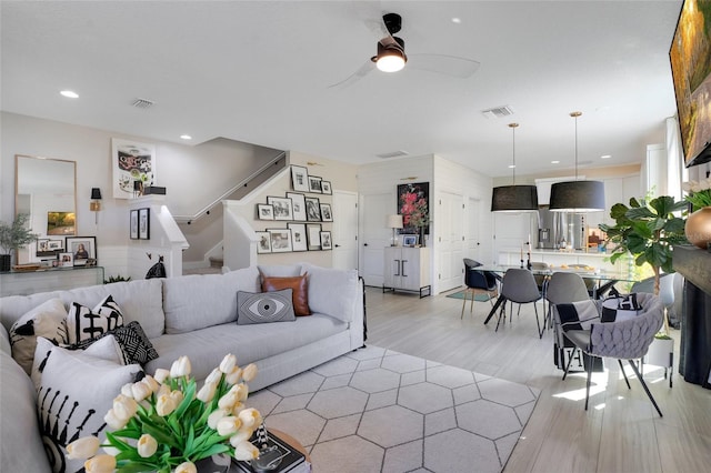 living room featuring ceiling fan and light hardwood / wood-style flooring